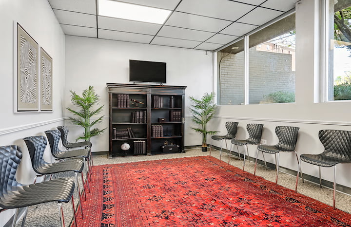 group room with bookshelf and rug