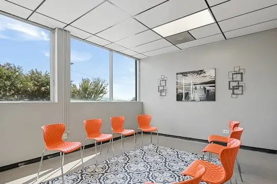 group room with bookshelf and rug