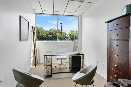 group room with bookshelf and rug