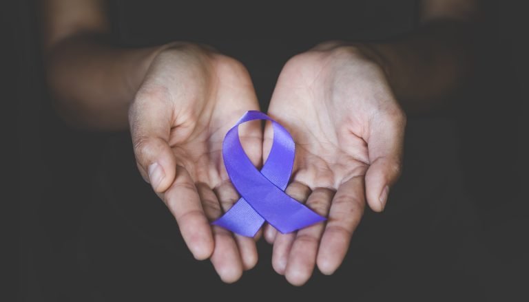Person holding a purple ribbon, symbolizing International Overdose Awareness Day held on August 31.